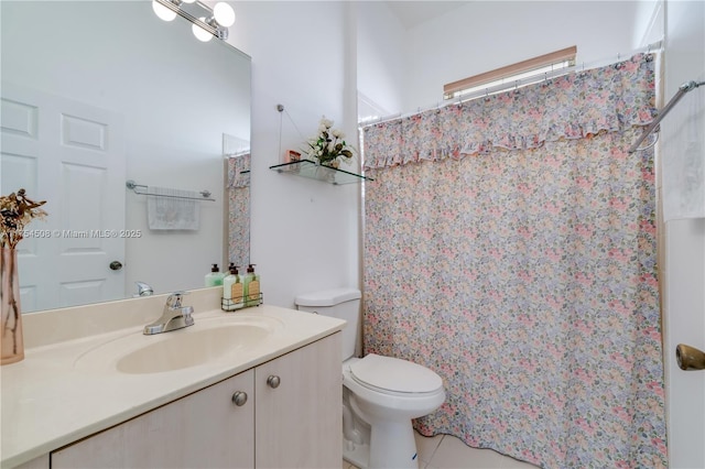 bathroom with toilet, tile patterned floors, curtained shower, and vanity