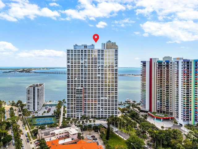 birds eye view of property featuring a view of city and a water view