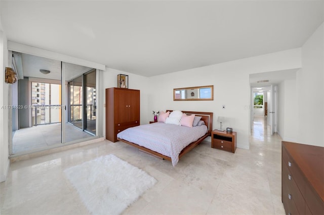 bedroom with floor to ceiling windows, multiple windows, and access to exterior