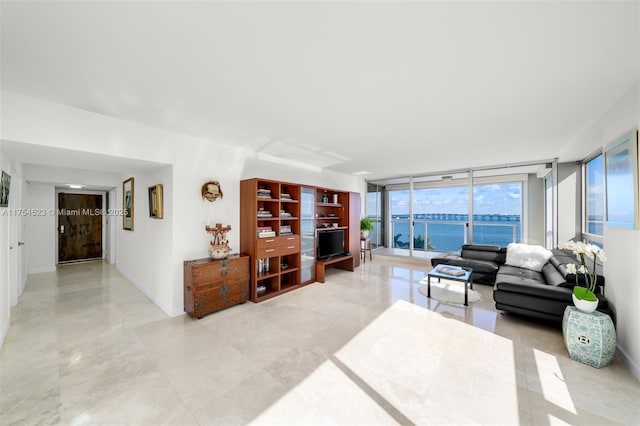 living area with a wall of windows and baseboards