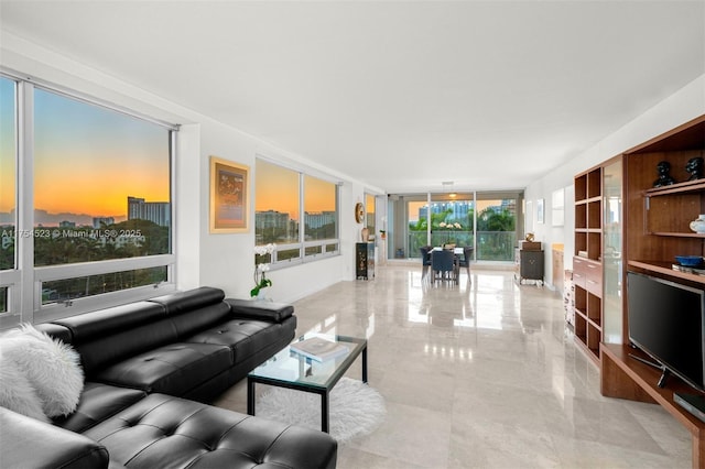 living area featuring marble finish floor and floor to ceiling windows