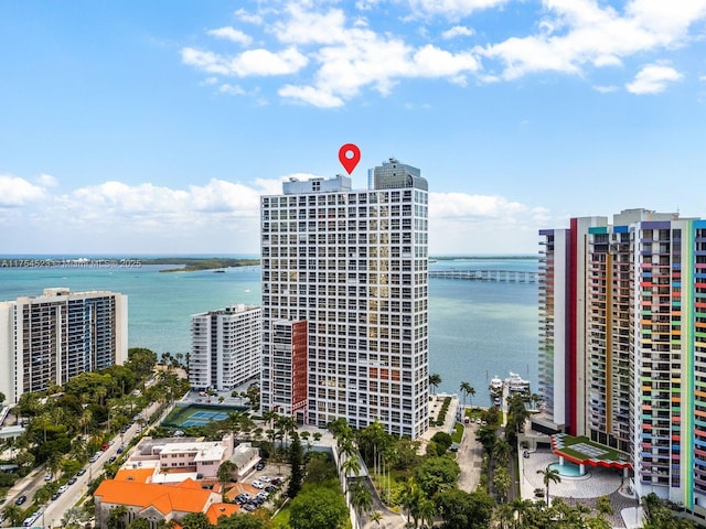 birds eye view of property with a view of city and a water view