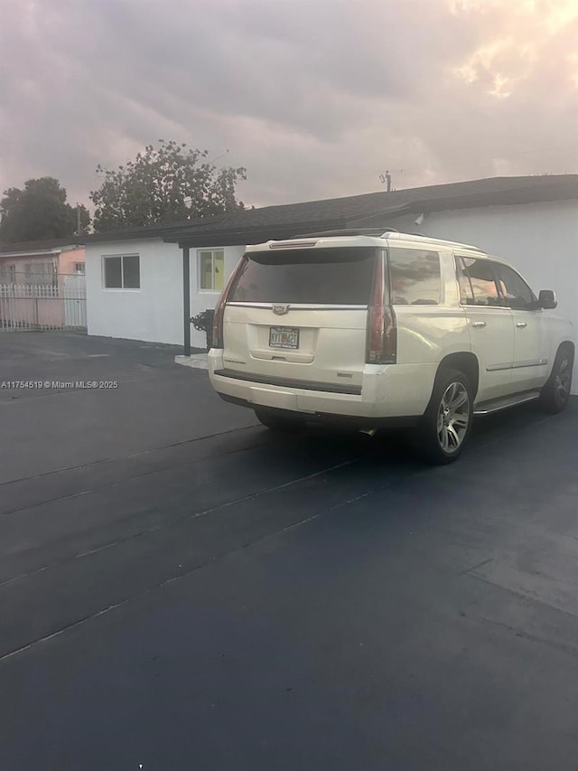 view of parking with fence