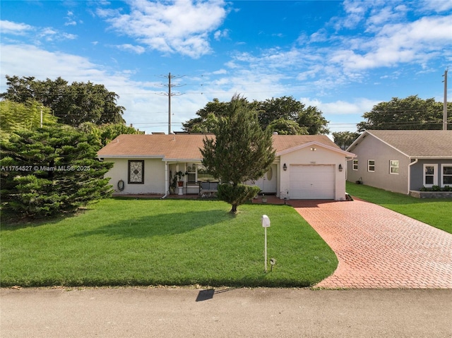 ranch-style house featuring an attached garage, stucco siding, decorative driveway, and a front yard