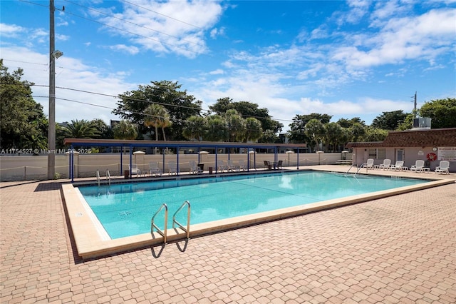 pool featuring a patio area and fence