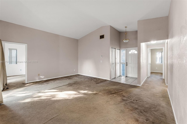 interior space with high vaulted ceiling, baseboards, and visible vents