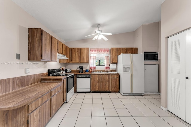 kitchen featuring under cabinet range hood, white appliances, a ceiling fan, vaulted ceiling, and brown cabinetry