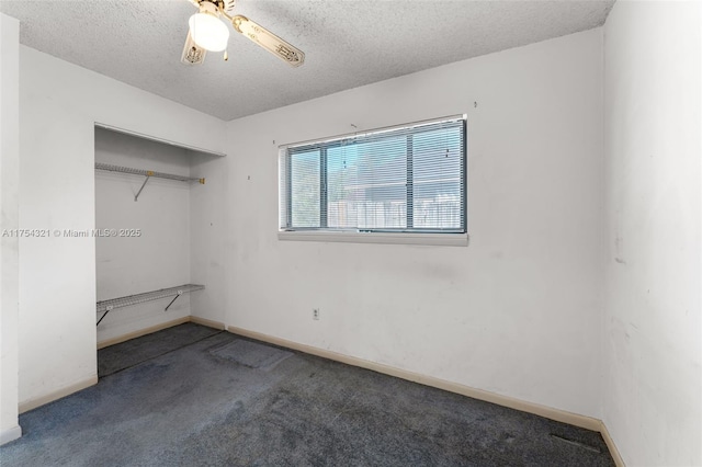 empty room with a ceiling fan, carpet, baseboards, and a textured ceiling