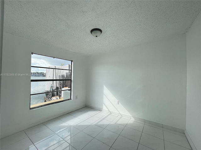 5790 W 26th Ave Unit 202, Hialeah, FL 33016 - spare room with a textured ceiling and tile patterned floors