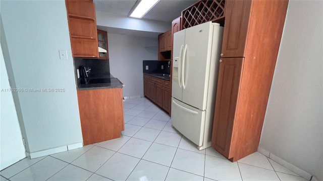 5790 W 26th Ave Unit 202, Hialeah, FL 33016 - kitchen with white fridge with ice dispenser, dark countertops, decorative backsplash, open shelves, and brown cabinetry