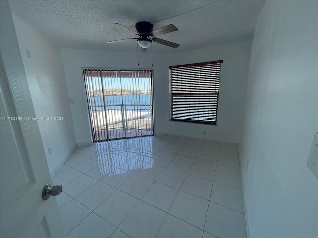 5790 W 26th Ave Unit 202, Hialeah, FL 33016 - empty room featuring a textured ceiling, light tile patterned flooring, and ceiling fan