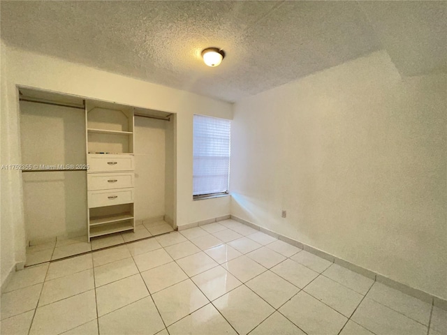 5790 W 26th Ave Unit 202, Hialeah, FL 33016 - unfurnished bedroom with light tile patterned floors, a textured ceiling, and a closet