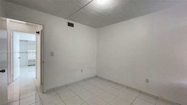 5790 W 26th Ave Unit 202, Hialeah, FL 33016 - spare room featuring light tile patterned floors and a textured ceiling