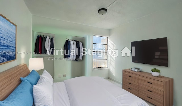 5790 W 26th Ave Unit 202, Hialeah, FL 33016 - bedroom with a textured ceiling and baseboards