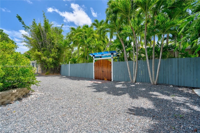 view of gate featuring fence