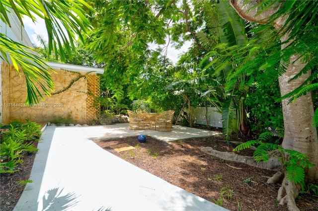 view of yard featuring fence and a patio