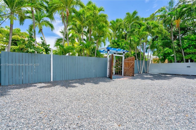 view of gate featuring fence