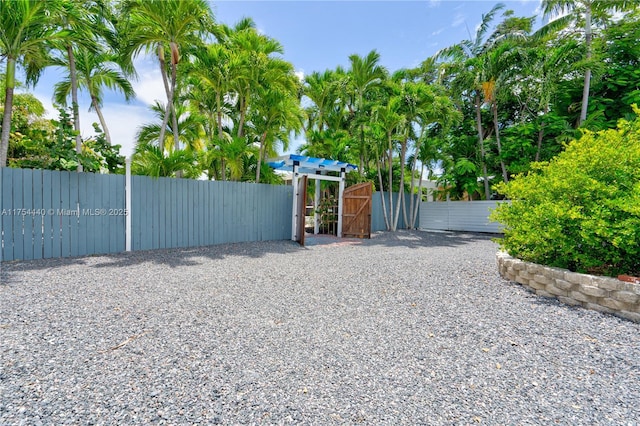 view of gate featuring fence