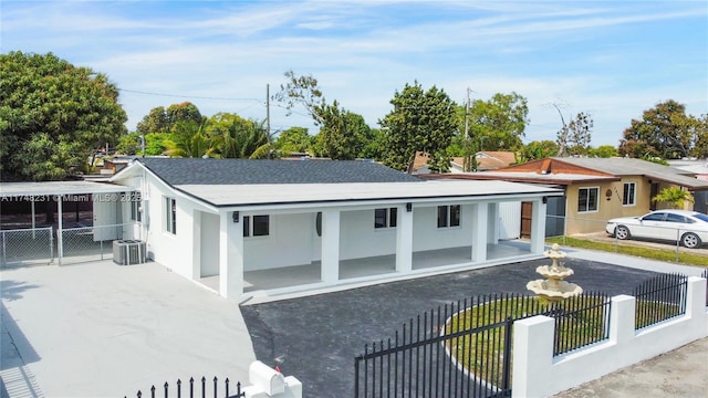 view of front of property with central AC unit and fence