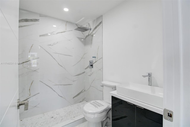 bathroom with toilet, recessed lighting, a marble finish shower, and vanity