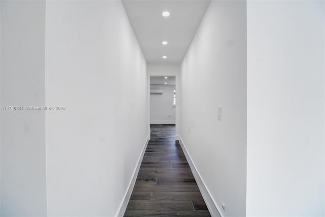 hall with a wall unit AC, baseboards, dark wood finished floors, and recessed lighting