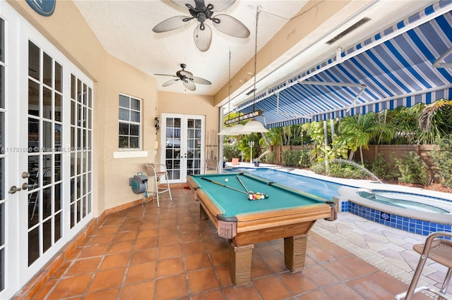 playroom featuring a textured ceiling, french doors, a ceiling fan, and tile patterned floors