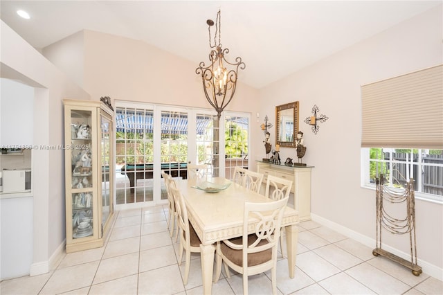 dining space featuring vaulted ceiling, light tile patterned floors, and a healthy amount of sunlight