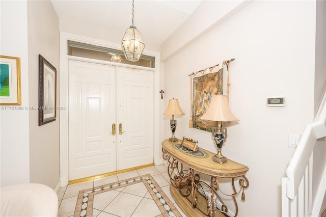 entryway featuring a chandelier and light tile patterned flooring