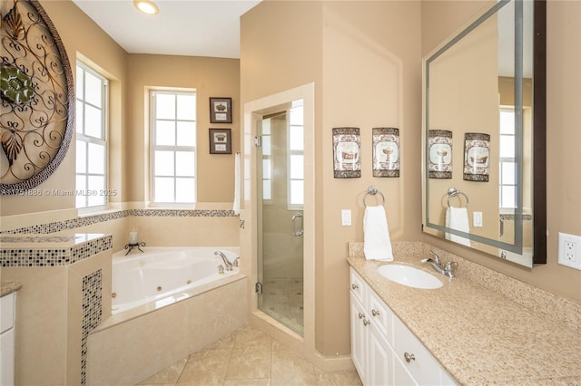 full bath featuring a whirlpool tub, a shower stall, tile patterned flooring, and vanity