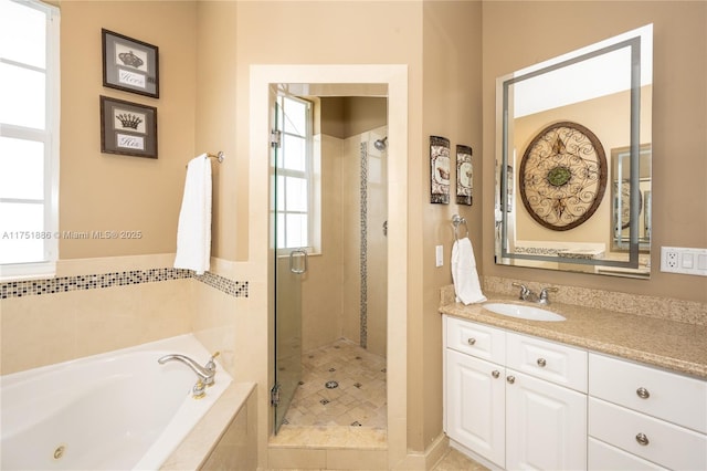 full bathroom with a whirlpool tub, a shower stall, and vanity