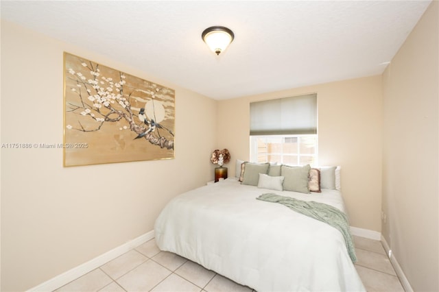 tiled bedroom featuring baseboards