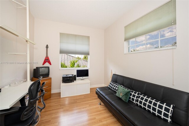 office area with baseboards and wood finished floors