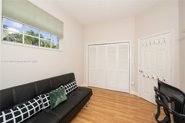 living room with light wood-type flooring and baseboards