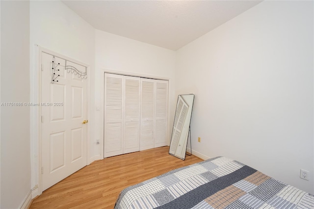 bedroom featuring light wood-style flooring and baseboards