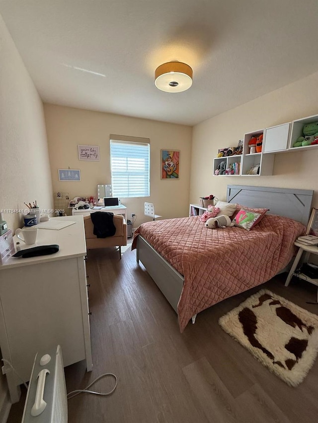 bedroom with dark wood finished floors