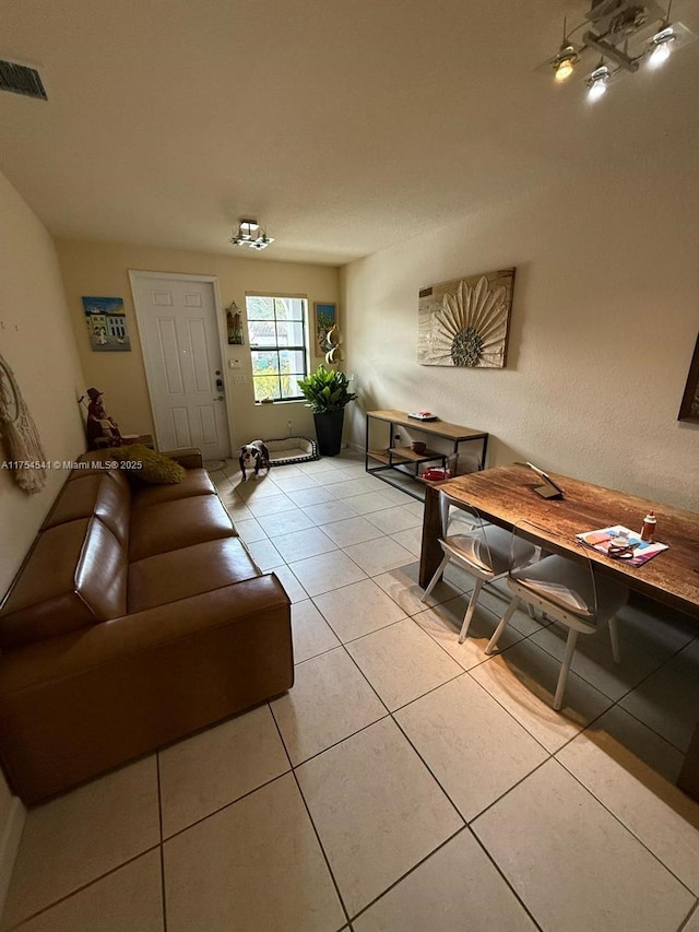 living room with light tile patterned floors and visible vents