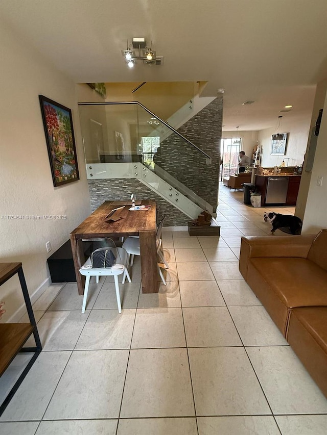 tiled dining space featuring stairs