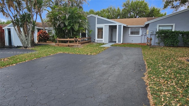 view of front of home with stucco siding and a front yard