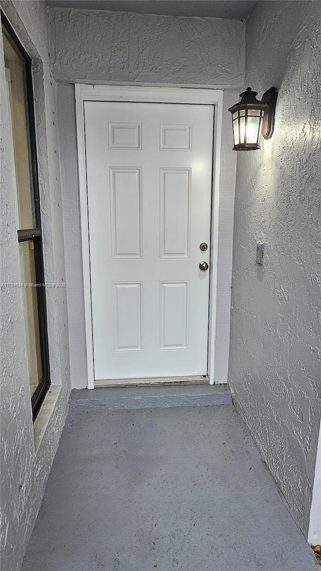 doorway to property with stucco siding