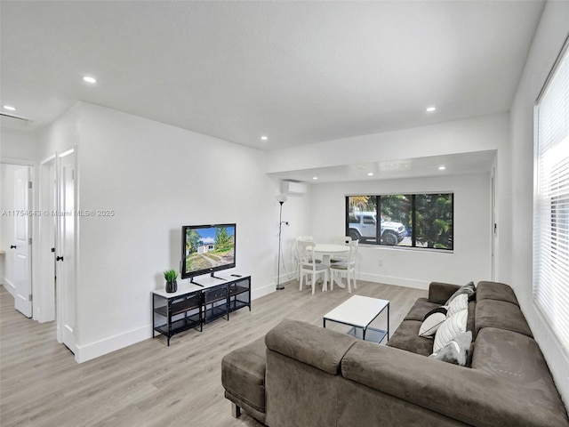 living room with recessed lighting, baseboards, and light wood finished floors