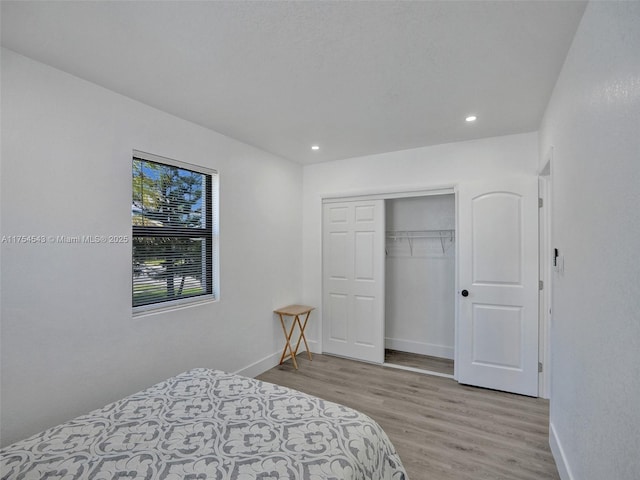 bedroom with recessed lighting, baseboards, and wood finished floors