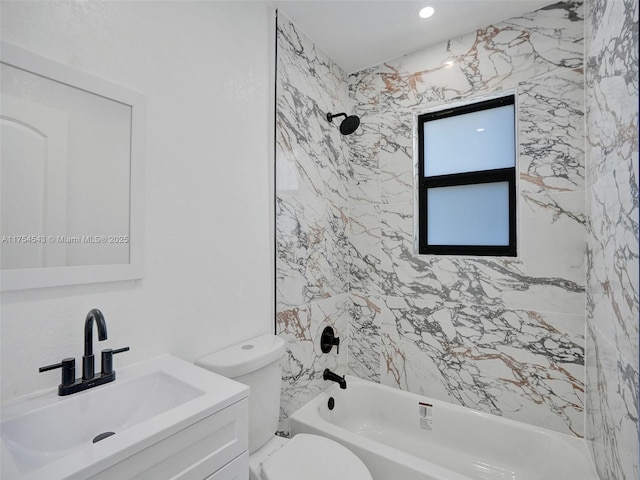 bathroom with tub / shower combination, vanity, and toilet