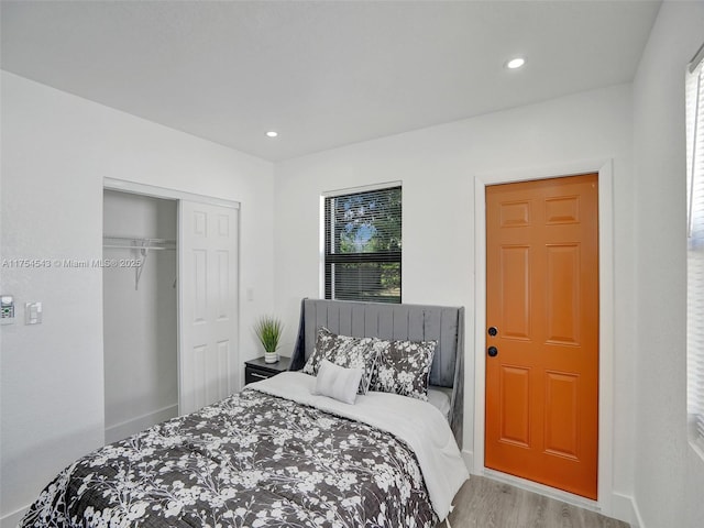 bedroom featuring recessed lighting, a closet, baseboards, and wood finished floors