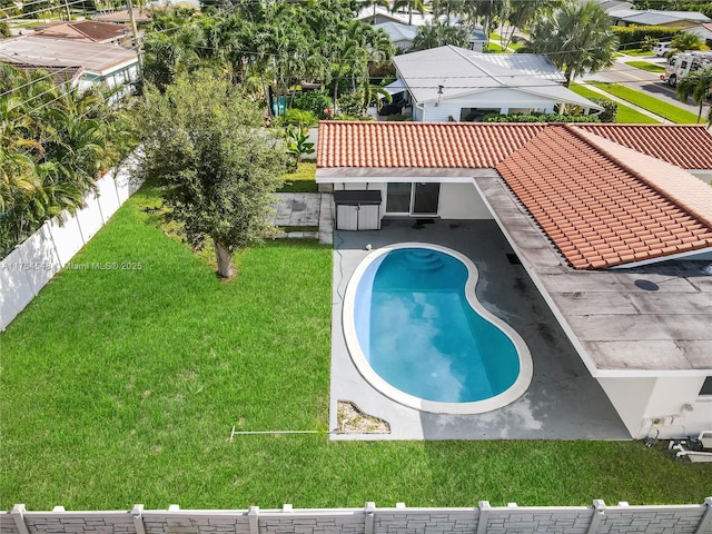 view of pool with a lawn and fence private yard