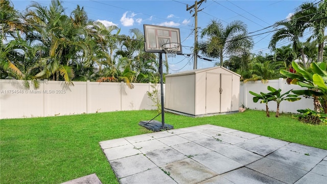 exterior space with a storage shed, a fenced backyard, and an outbuilding