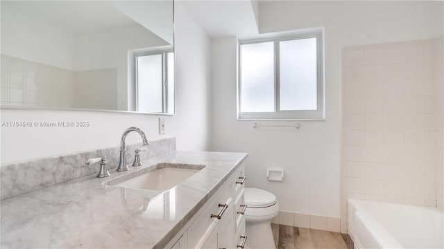 full bathroom with toilet, baseboards, wood finished floors, and vanity