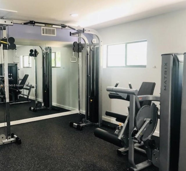 workout area with a garage and visible vents