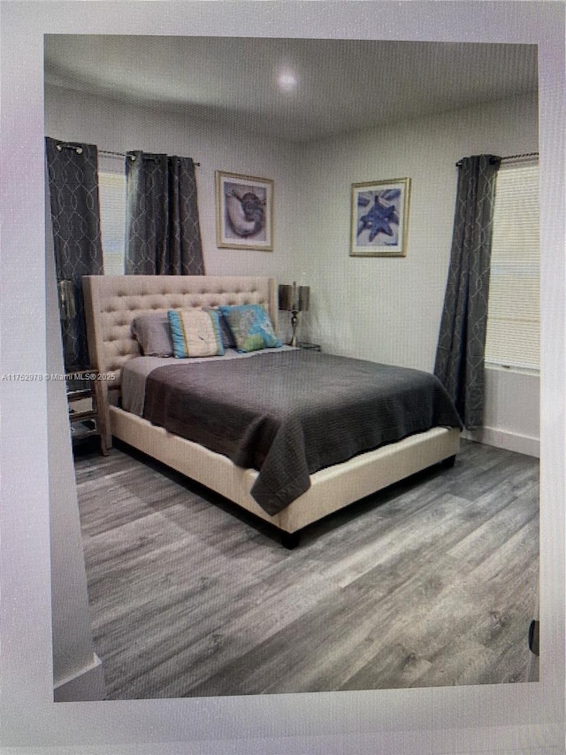 bedroom with recessed lighting and wood finished floors