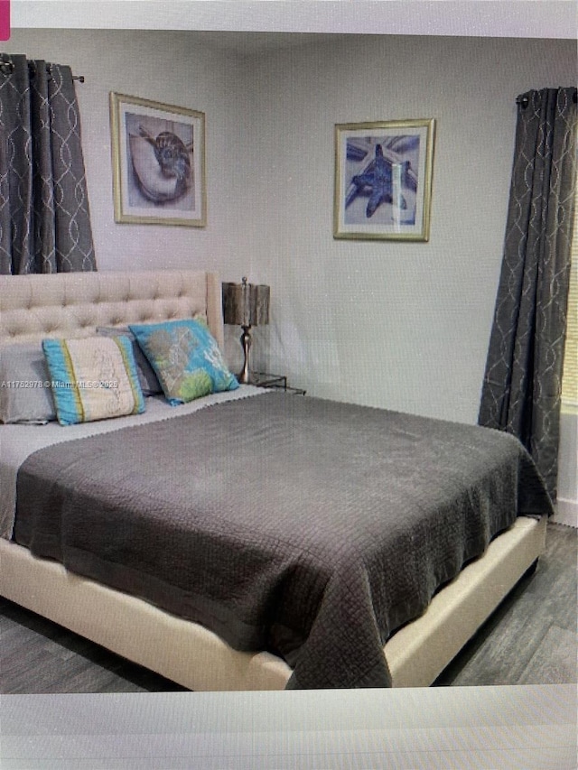 bedroom with wood finished floors
