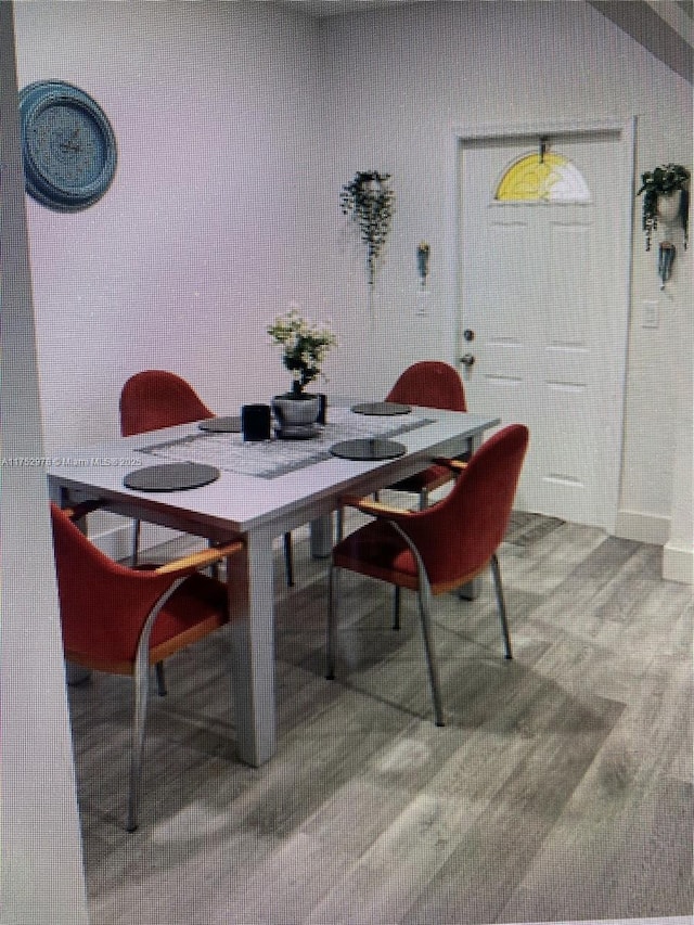 dining space with wood finished floors